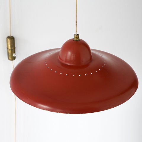 Adjustable wall-mounted lamp in brass and with red aluminum shade. Italy, 1950s.