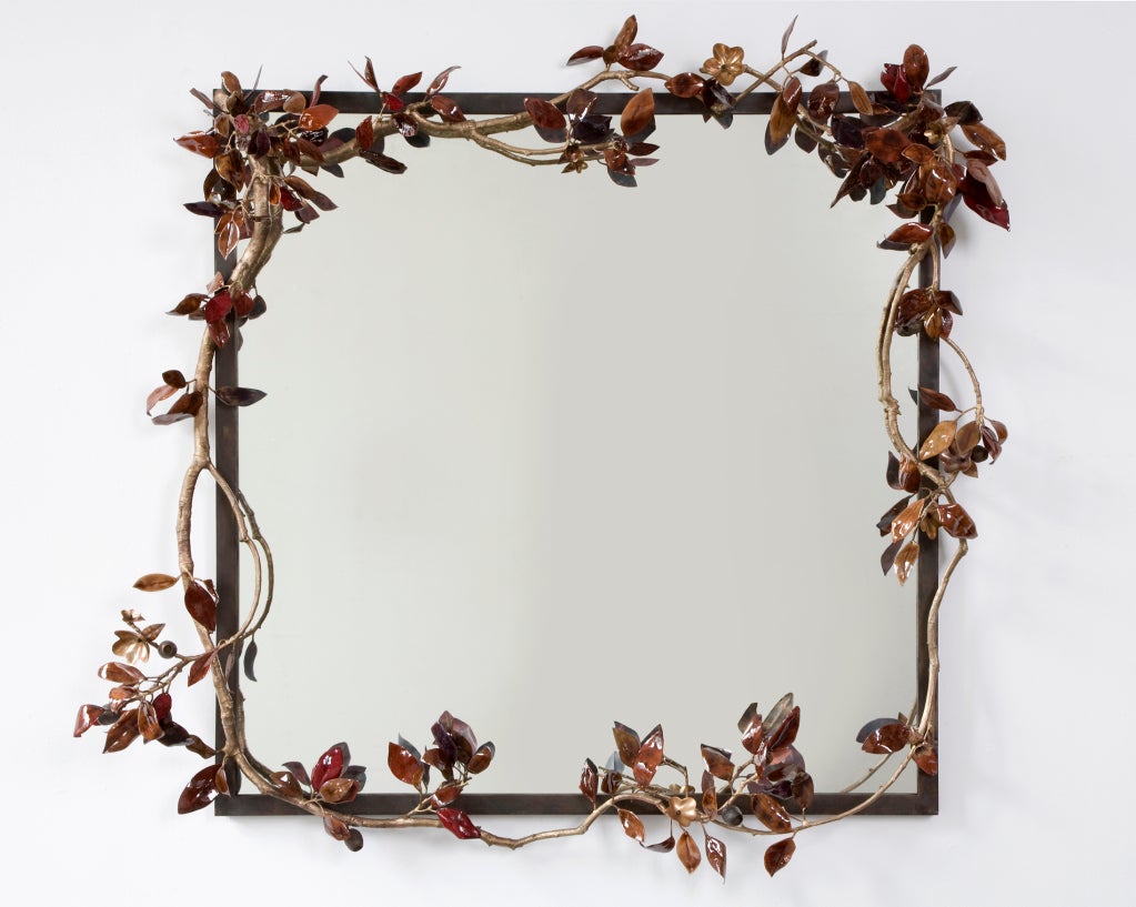 Custom commission of a mirror surrounded by bronze cherry branches with leaves in enameled glass and glazed, colored porcelain budding plums, designed by David Wiseman, USA, 2011.