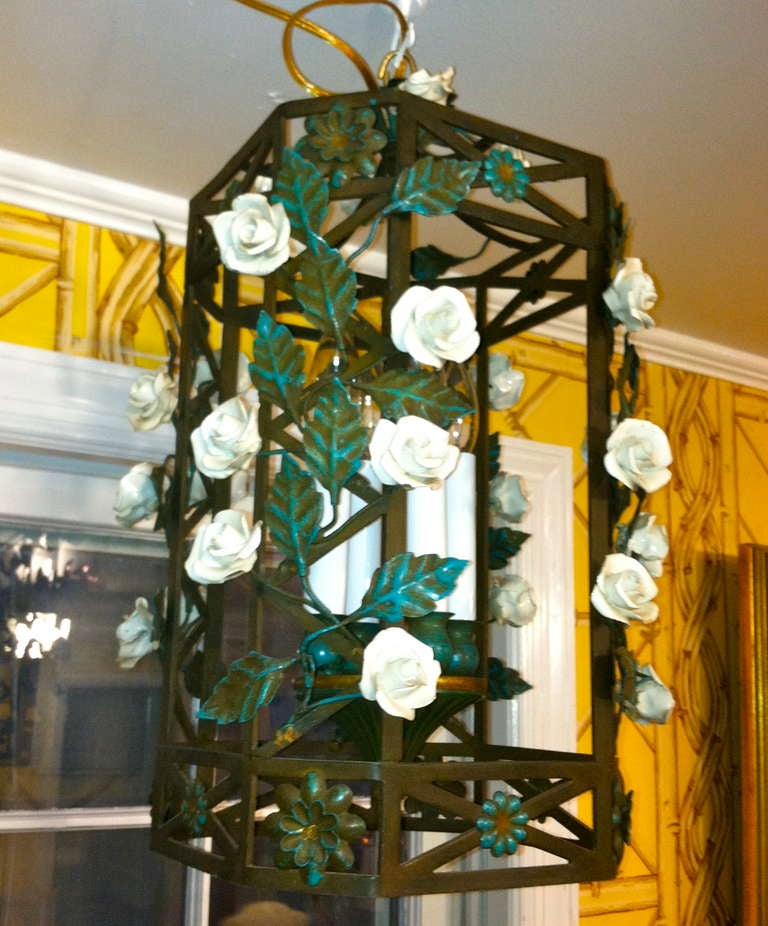 20th century French painted tole lantern with porcelain flowers.