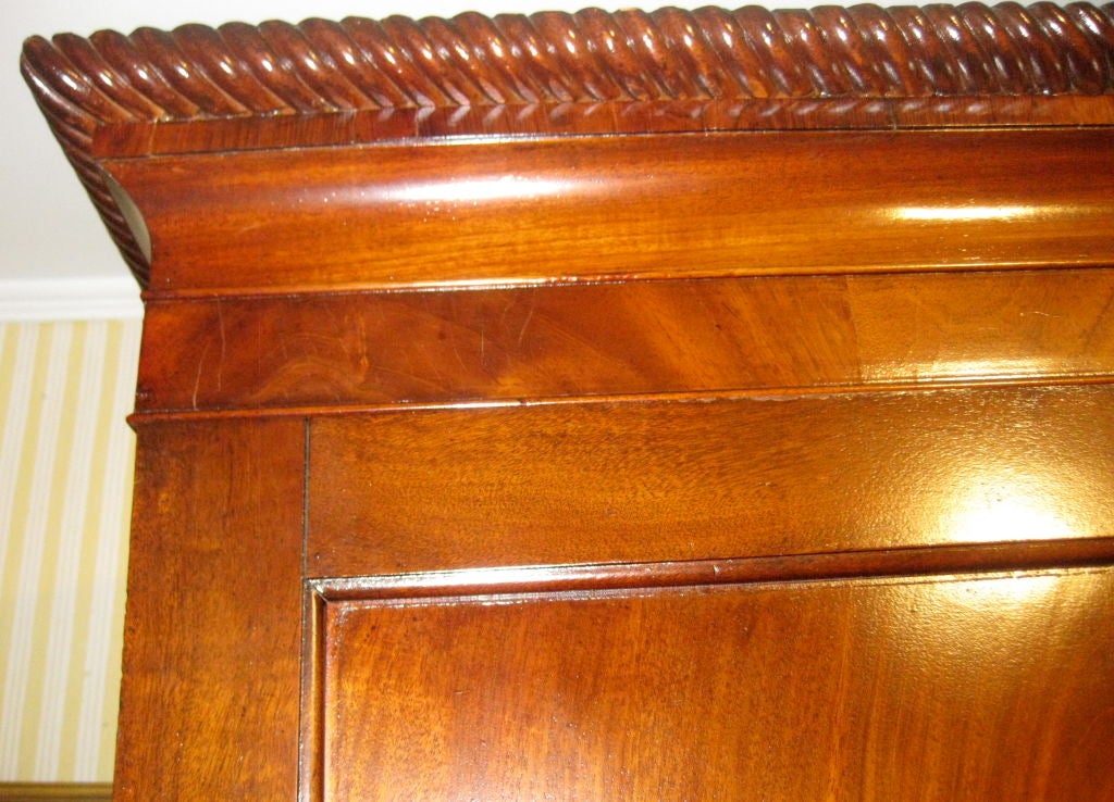 Irish 19th Century Mahogany Linen Press, <br />
with molding around the top crown and drawers, beautifully executed; the front doors have wonderful flame grain  with honey color mahogany on doors; having four original interior shelves and original