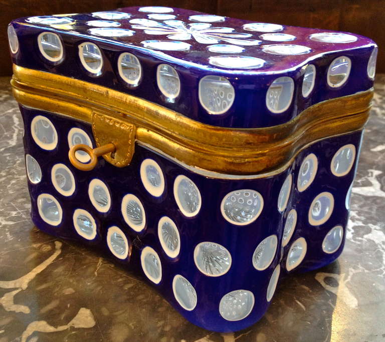 19th century French cobalt blue overlay on milk glass box, thousand eye pattern with brass fittings, working lock and key.