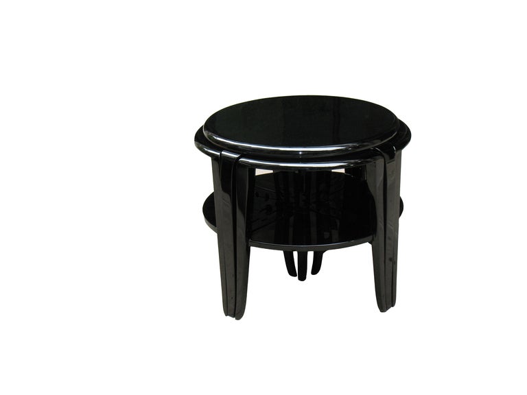 
The center table of this rare French Art Deco nest of tables with four saber legs on 