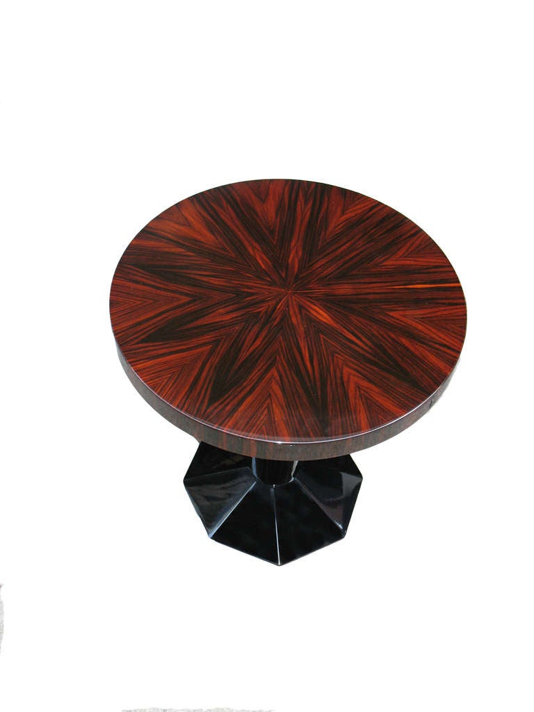This rare pair of French Art Deco side-tables is exceptional: sunburst makassar - veneered table-tops with cross-grain veneered edges. Circular conical pedestals, octagonal bases with 8 splayed panels (pedestals and bases black lacquered).

Ritter