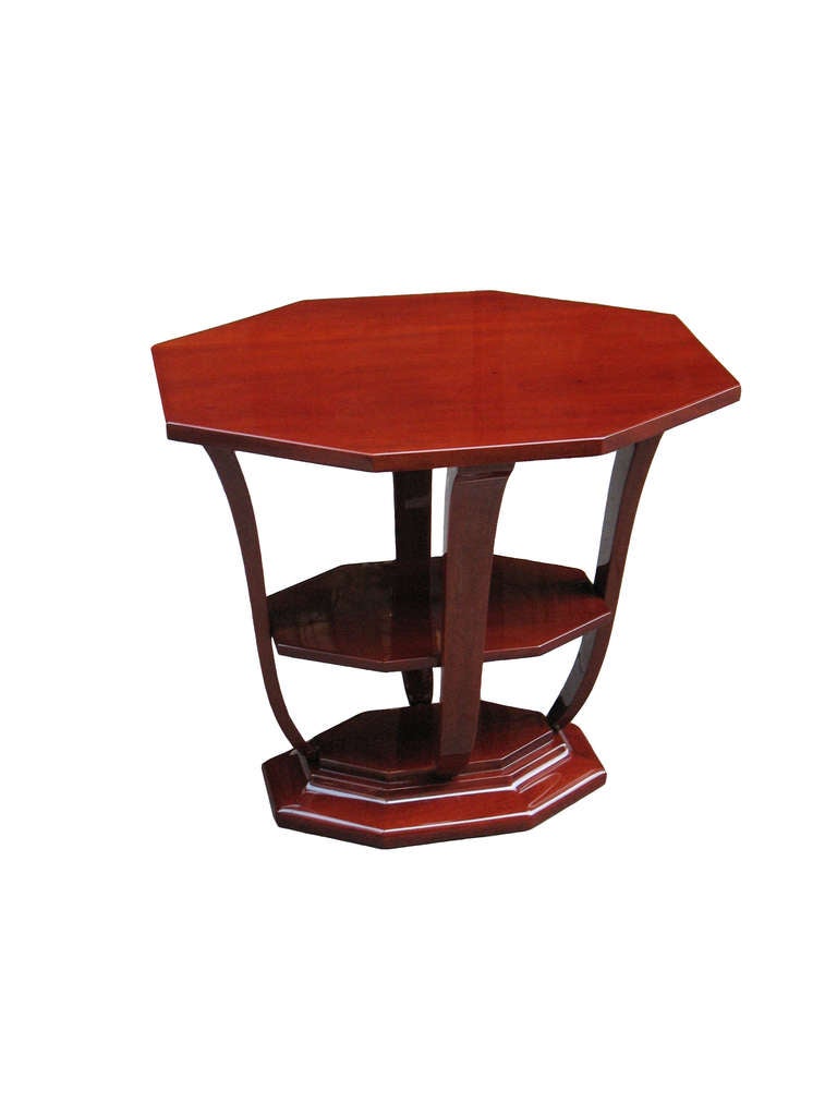 This octagonal French Art Deco side-table in rosewood is topped with a fitted Glass tray with rosewood molding and handles. Raised on 4 curved supports with plateau over corresponding octagonal base.

Ritter Antik is dealing in authentic