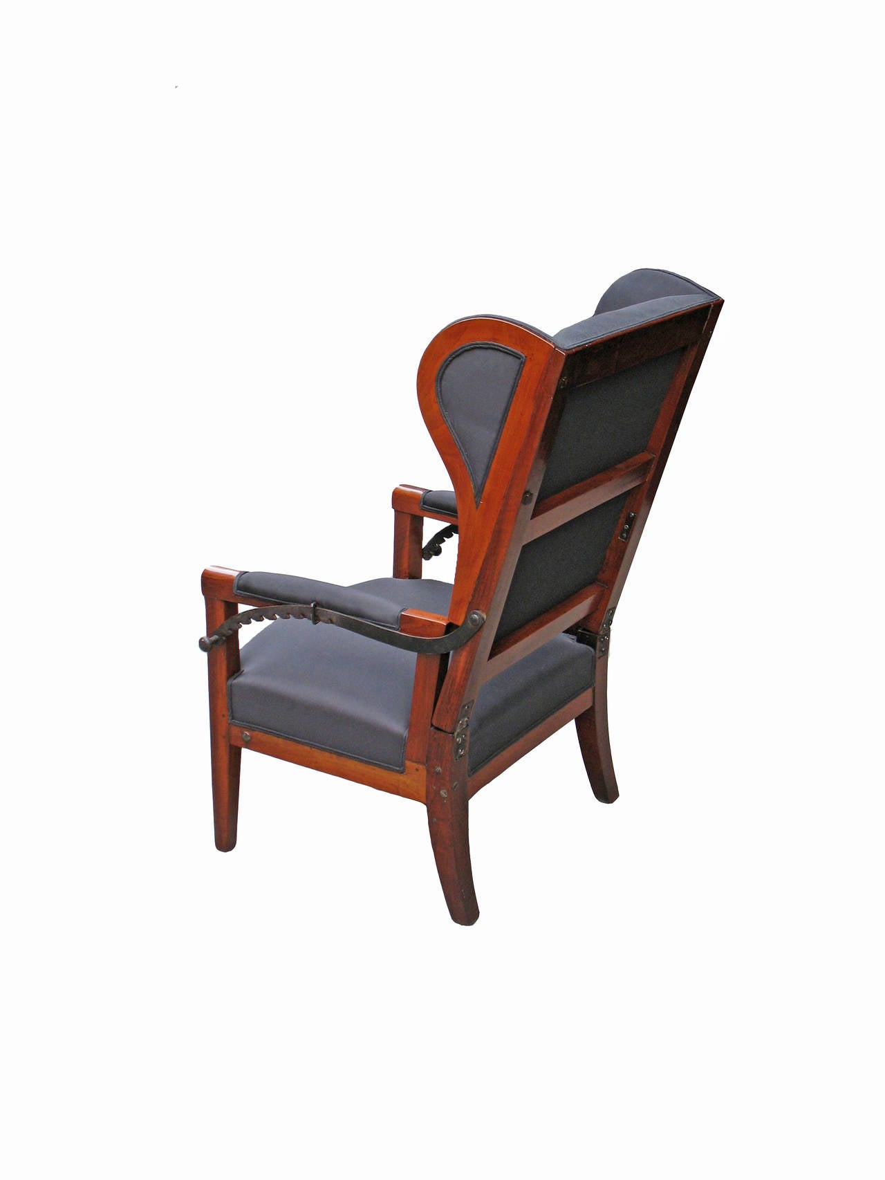 A wing chair characteristic for this furniture type in South Germany, but very special with an adjustable seat back. It's mechanism is original and functional. Solid walnut frame shellac based French re-polished. Re-upholstered with webbing,
