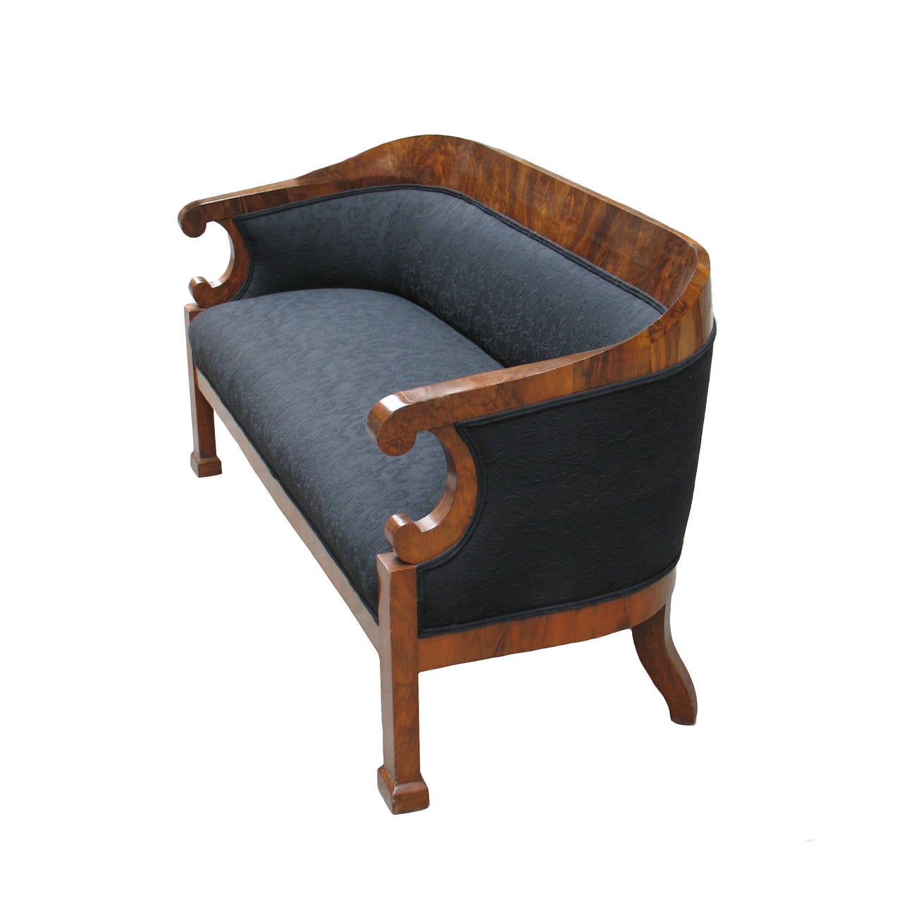 This comfortable Biedermeier barrel back sofa from the 1820s is exemplary for the popular Viennese barrel back design from the 1820s. 
Walnut standing root-head with exceptional grain configuration. 
Veneered on pinewood. Shellac-based French