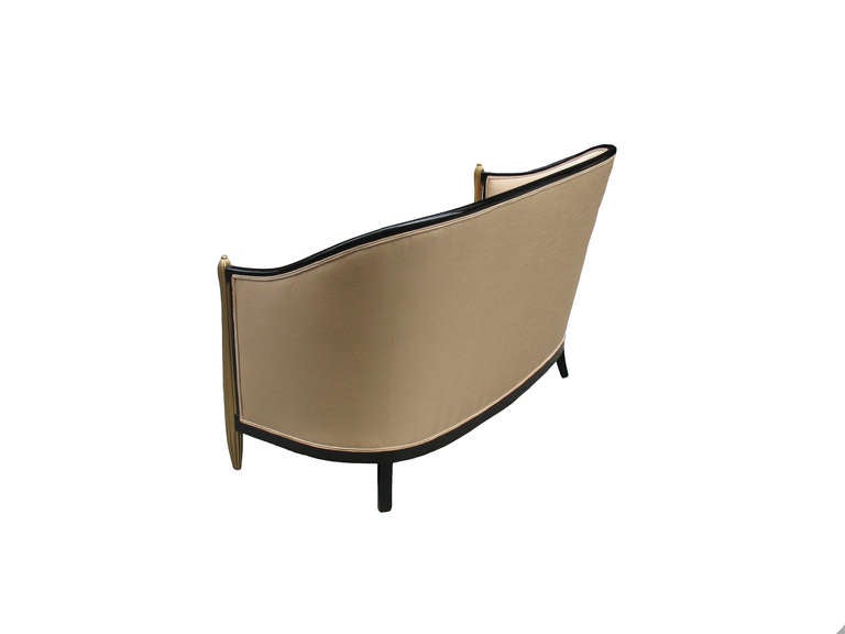 This comfortable French Art Deco settee (love seat in the style of Paul Follot (1877-1941) with sculpture barrel-back ebonized beech wood frame and free standing fluted and swollen front-posts can neither hide his education as an sculptor (by Eugene