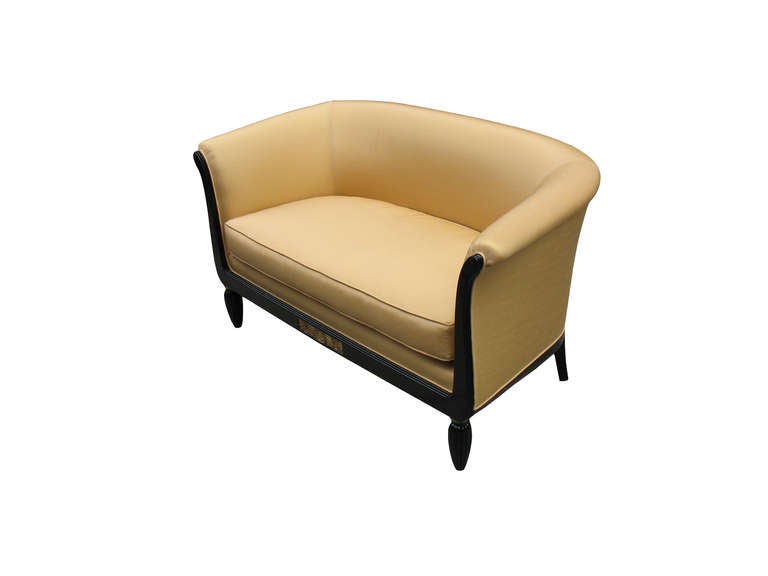 This comfortable French Art Deco suite (comprising of a settee/love seat and a pair of bergeres) is fine detailed: the ebonized beechwood frames are lyre-shaped with barrel-backs, the sides are twice and the rail on top fluted and raised on fluted