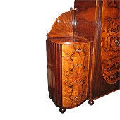 This magnificently detailed and uniquely designed Art Deco armoire with French influence was produced as part of a bedroom suite in the 1930s in Munich. Veneered with walnut in extremely well book match pattern. Two-door arched center-part flanked