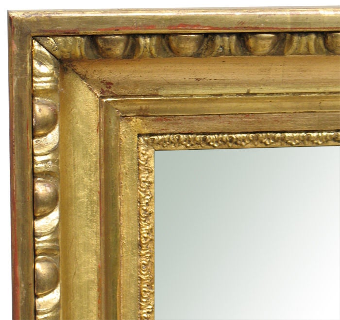 Exemplary Austrian Biedermeier gilt wood frame with "egg & dart" molding and finely detailed stiff leaf border surrounding the mirror plate. Retaining it's original gilding with a rare combination of oil gilded and (more shiny) water