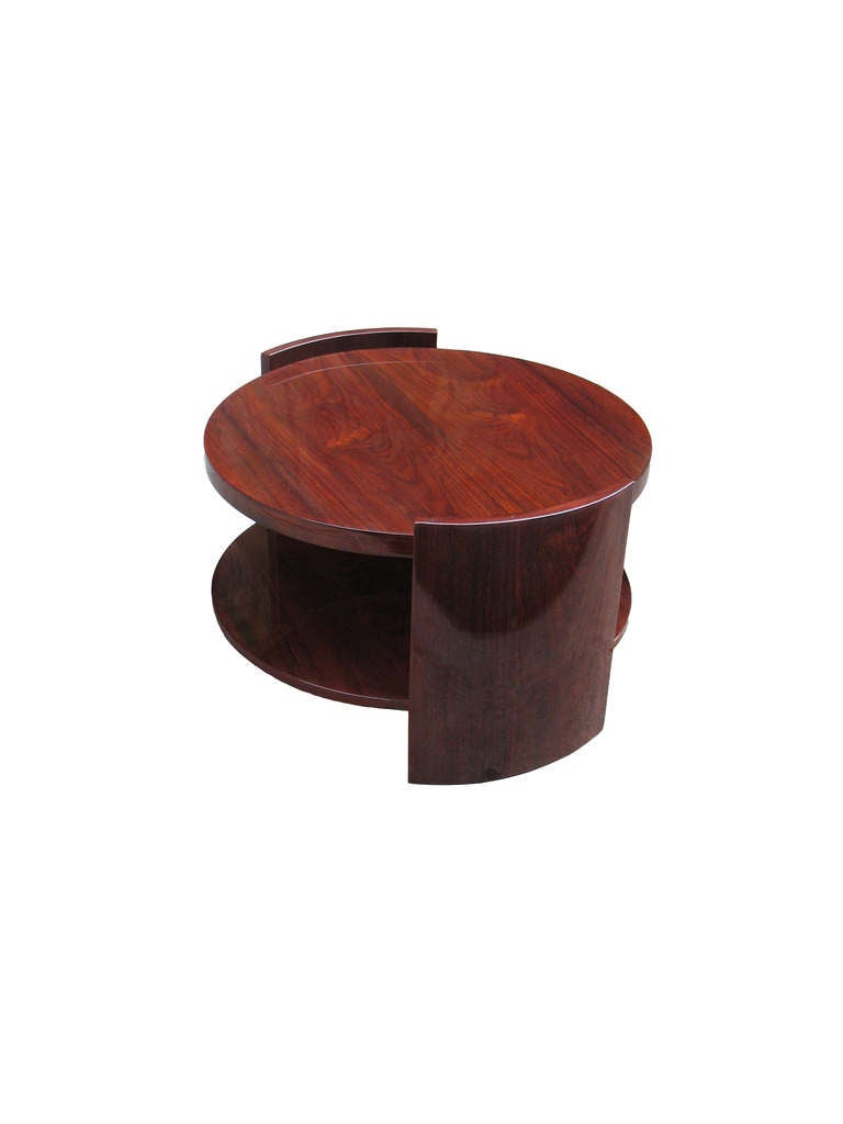 A slightly oval two plateau French Art Deco side table. Unusual concave shelf supports on either side. Veneered with bookmatched rosewood on beech-tree.

Ritter Antik is dealing in authentic Continental period furniture and is specializing in