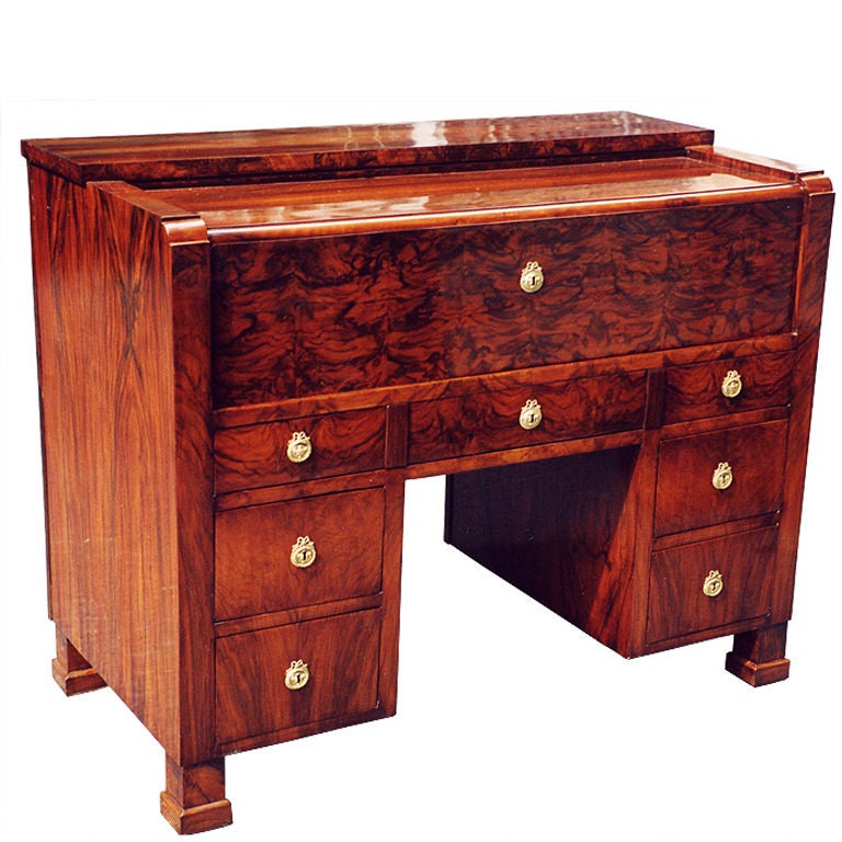 This Austrian/Hungarian Biedermeier desk is exemplary in design, very rare, sturdy constructed and functional. Matching veneered with walnut on pine on all sides for free standing. Front with one large drawer  over a pair of smaller drawers on
