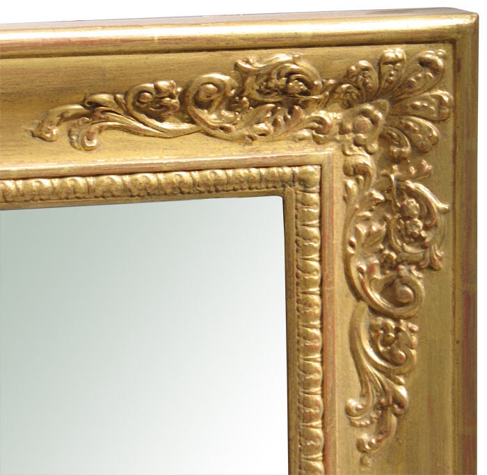 Biedermeier gilt wood pier mirror with beautifully detailed plaster relief motifs (leaf tips, laurel leaf clusters with rosettes and corner foliage with palmettes). Original mirror plate bordered with a stiff leaf gilt wood molding. 

References are