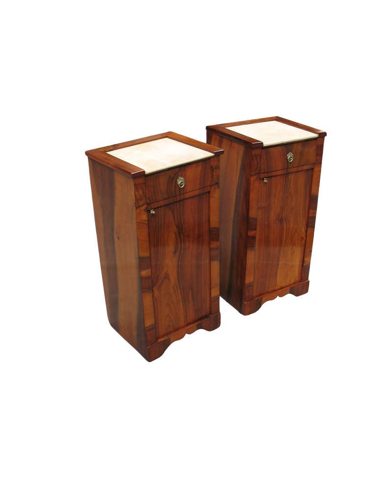 This rare pair of Biedermeier side stands/commodes is matching veneered with walnut on pine. Original 