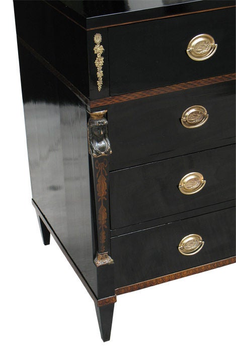 Ebonized pear wood (the rule how it was done in Biedermeier) on oak. Inlaid with maple hairline and two fillets with finest original pen-works. Frieze drawer with brasses over Egyptian caryatid supports in their original Verde antico paint, parcel