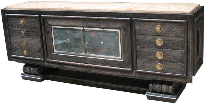 A unique French Art Deco buffet by Jean-Charles Moreux (1889-1958) in ebonized white oak with cerused finish (grey-blueish shiny surfaces including black grain lines.) Three-times paneled front. The two-door center part with original etched mirrored