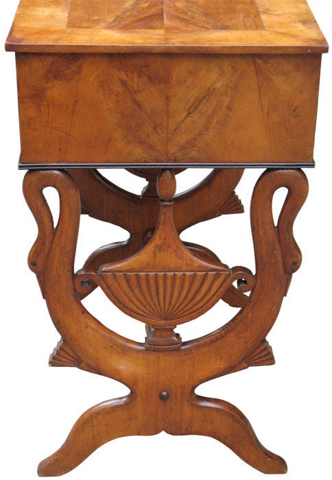 This classical antiquity - inspired Biedermeier side table with lyre-shaped sides, fluted urns with lid and looped swans in cherry wood (solid and book-match veneered on pine with ebonized trim) is unequally designed. Constructed with tilt-top,