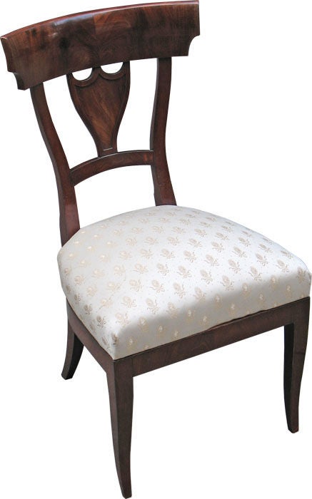Set of six elegantly shaped comfortable Biedermeier side chairs. Mahogany on oak. Waisted seat-backs with shovel-shaped shoulder boards and urns with molded edges. Drop-in seats. Saber legs.

References are included in our "Certificate of