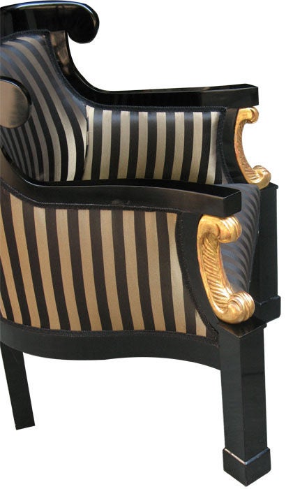 A pair of large and comfortable Viennese Biedermeier bergeres or club chairs. Ebonized barrel-back frames, shovel-shaped shoulder boards, lyre-shaped rail and angled block feet bring all attention to the gilt wood "C" volutes.

References