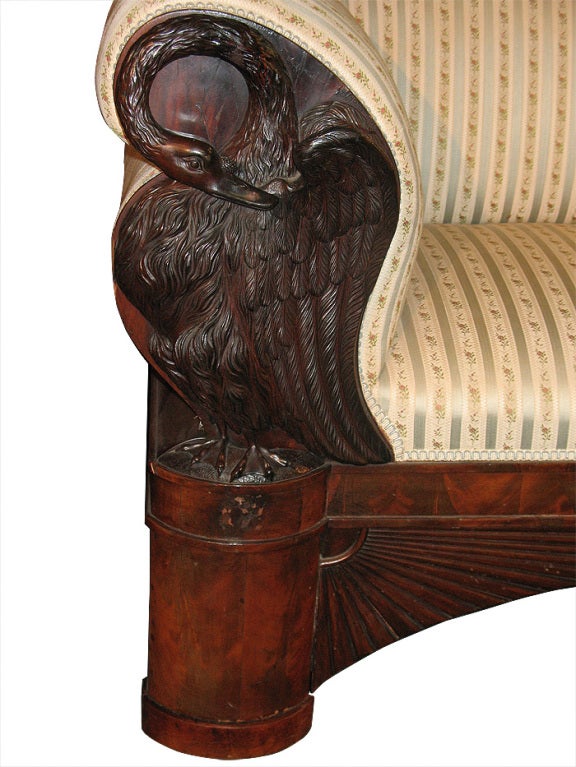 A Biedermeier sofa of Museum quality (indeed, an identical sofa is in the Hamburg Museum "Jenischhaus"). Book-match veneered with mahogany on pine. Sides with magnificently detailed wood-carved sculptured swans with the original aged