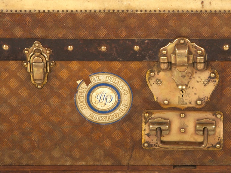 antique trunk. hand painted canvas. leather trim with tack nail detail. brass hardware.