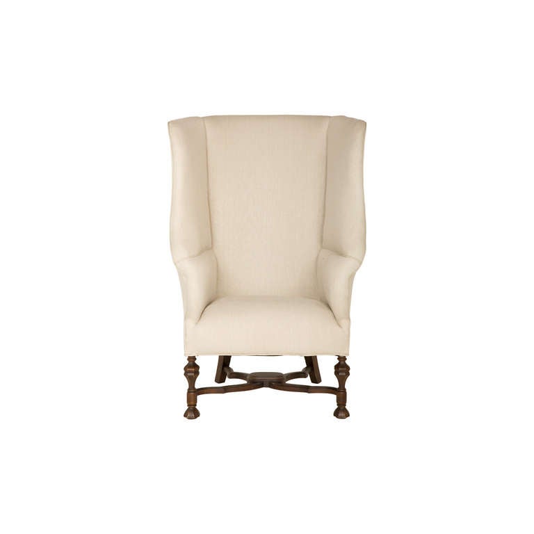 vintage wingback chair. reupholstered in natural linen. original leg finish.