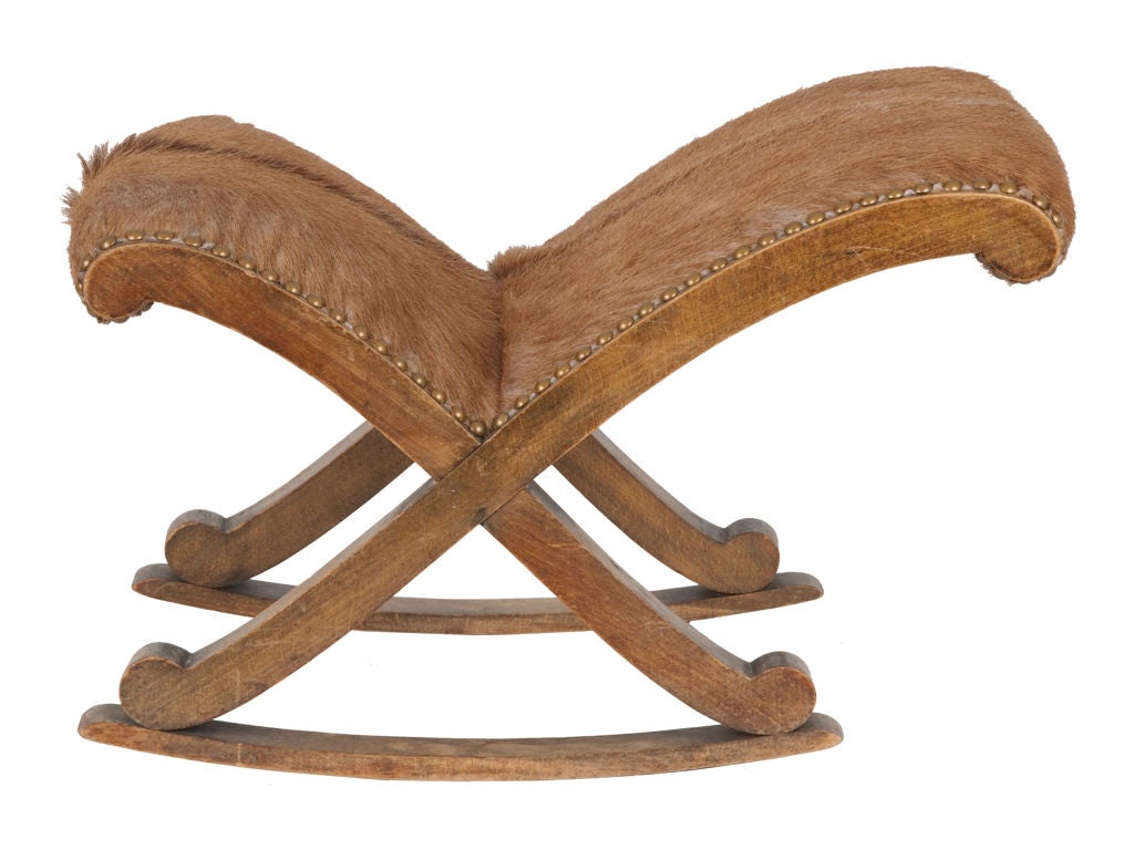 Vintage wood rocking footstool. Reupholstered in goat hide with antique brass nailheads.