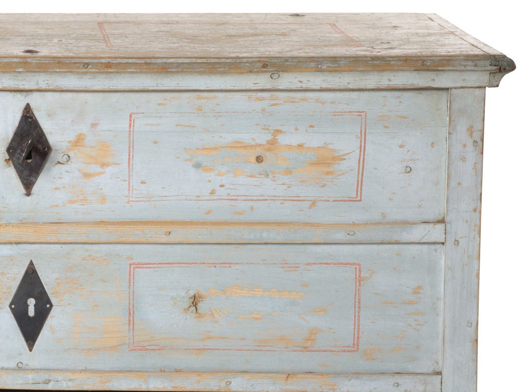 Beautifully patinaed painted chest. Original painted finish. Top opens with two false drawer fronts. Functioning bottom drawer.