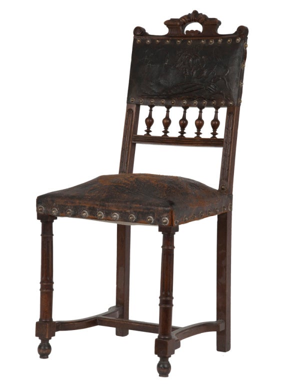 Antique dining chair. Original stamped leather upholstery. Unique nailhead trim detail. Carved wood frame.