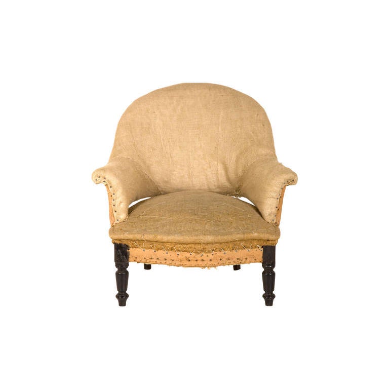antique napoleon III barrel chair. unupholstered frame as found. muslin and burlap with tack nail trim.