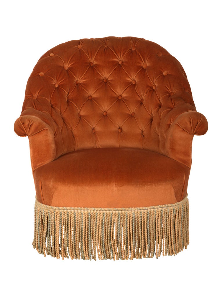 antique tufted chair. velvet upholstery and fringe as found.