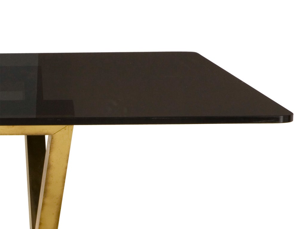 vintage dining table. original smoked glass top. brass base.