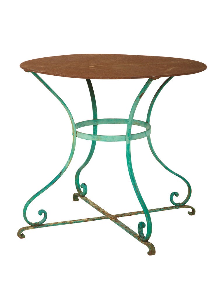 antique garden table. charming patina. wrought iron. painted finish as found.