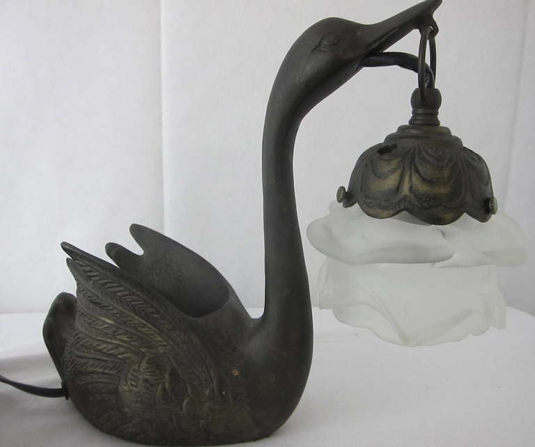 Amazing pair of  Art Nouvea cast iron swans lamps! Each Swan has incredible detail and  an opening for plant flowers if you choose. The lamp shades are satin glass flower shape. 

Exciting and rare lamps! 

MEASURE ABOUT 9 INCHES TALL.