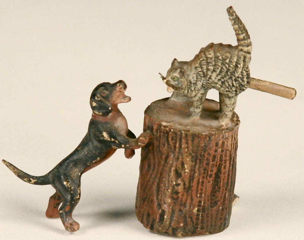 Fighting like cats and dogs! Diminutive and charming, this piece features two pets at odds with each other at the chopping block (complete with axe and a split log). Please Note: Not all items are actually in this location at any given time. If