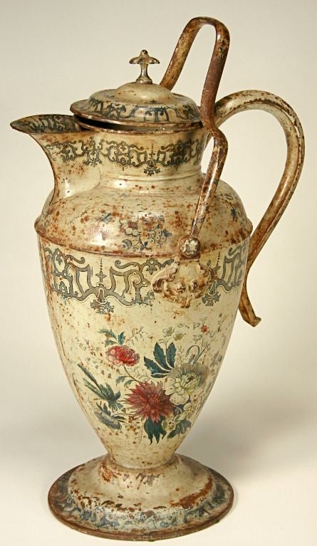 This beautiful Victorian covered ewer or pitcher fairly oozes character! Made of heavy-gauge tin, it is decorated overall with a hand-colored floral transfer pattern. Marked on the bottom, 