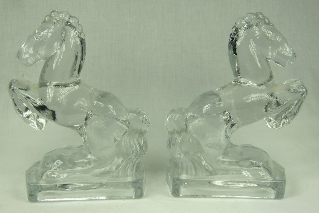 Featured is a pair of horse bookends made of thick, heavy glass.  The glass is crystal clear and the bases are hollow.<br />
<br />
We invite you to visit our boutique when in San Francisco! Thank you!