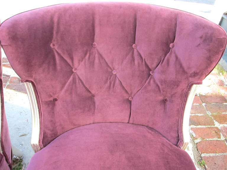 Great pair of Hollywood Regency tufted  chairs covered in a beautiful purple velvet and purposely aged silver frame and legs. 
Height: 33