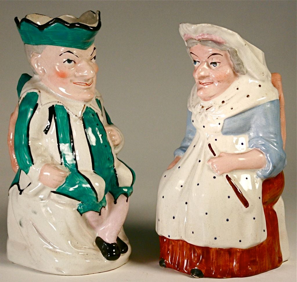 Offered is a charming pair of Staffordshire pitchers depicting Punch and Judy (you DO know who they are, don't you?). Each is approximately 10