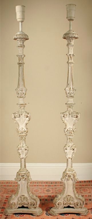 Offered is a pair of beautiful floor lamps carved in the Rococo style and electrified later. The lamp bases currently accept a large-size (