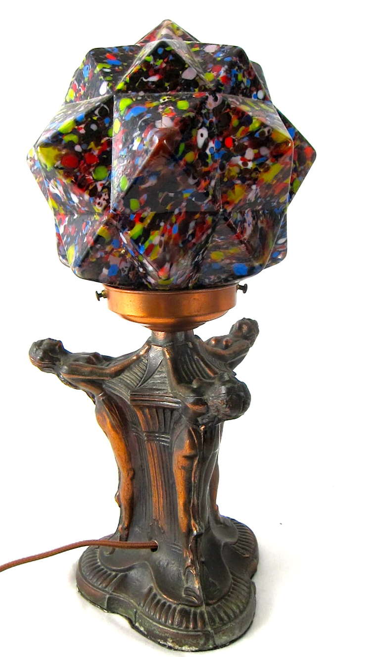 Wonderful Copper metal table lamp with three detailed flapper girls holding an End of the Day Starburst multi-colored glass globe. Beautiful! 
16