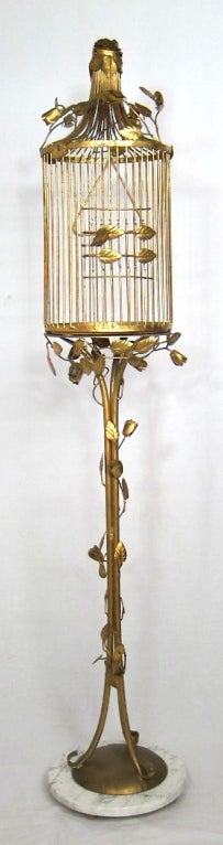 Beautiful gilt birdcage on a metal bese.

Total height: 61