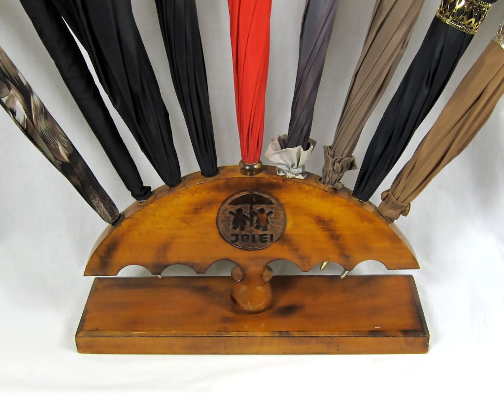 Featured is a collection of vintage umbrellasthe brom Bamberg Germany. The umbrella stand is probably c 1940's.  Each umbrella has it's own special interior design and jeweled handles. Ne umbrella Italy tag. This is a great for umbrella collectors.