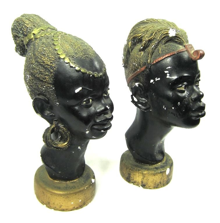 Feature are a pair of African male  & Female busts.They are made from some type of ceramic/plaster.  They are nicely aged.<br />
Please e-mail or call us with questions as our vintage and designer items are not returnable. We invite you to visit