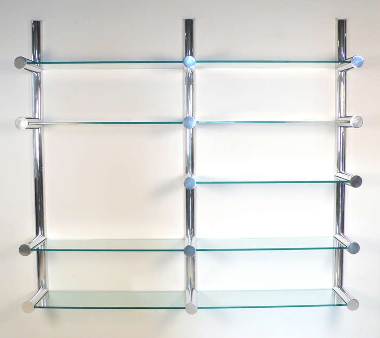 Orba Wall System designed by Janet Schwietzer for the Pace Collection NY. Set consists of nine cantilevered glass shelves held in place by three vertical wall mounted uprights constructed of polished aluminum. A stunning wall unit that is every bit