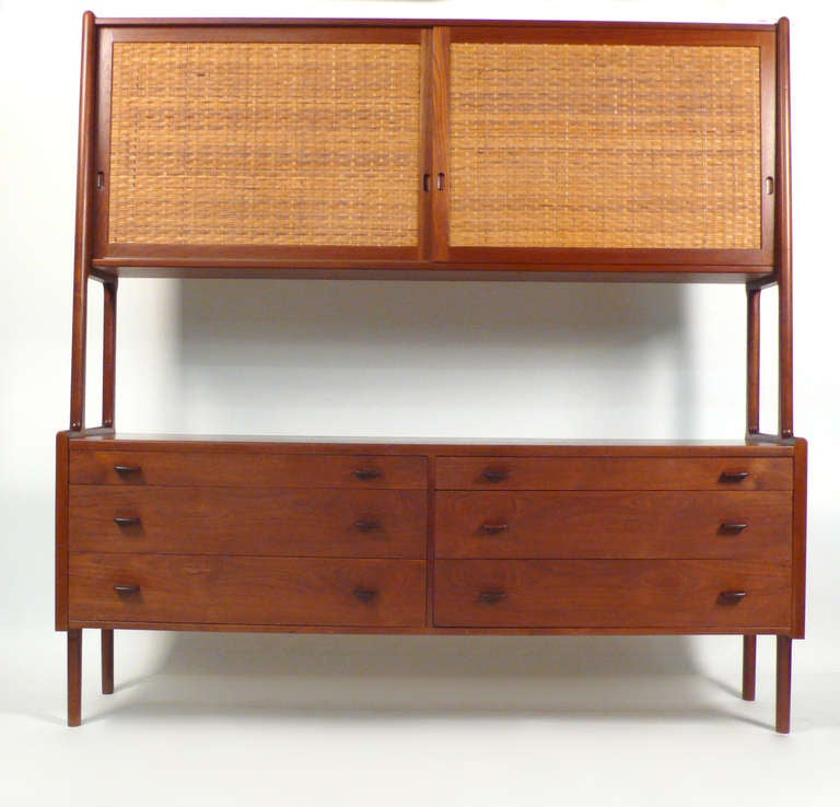 Top cabinet consists of sliding doors and adjustable shelves over lower cabinet with six drawers. Manufactured by Ry Mobler and sold through Illums Bolighus of Copenhagen. Model # RY20.