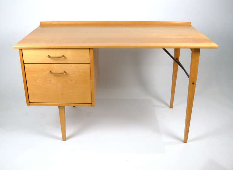 Solid maple desk with a brass stretcher and handles manufactured by Murray furniture and designed by Milo Baughman. This piece has been completely refinished and is in perfect condition. Works Well with Paul McCobb Planner Group.
