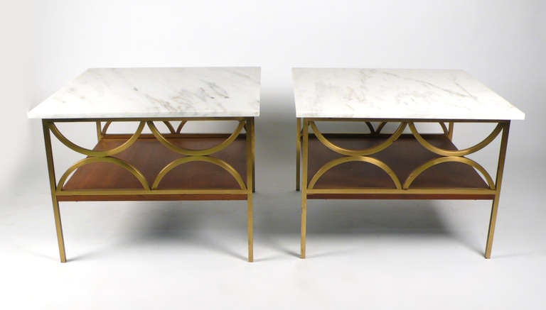 Side tables. Beautiful and unusual tables constructed of brass with wood shelf and honed Calcutta marble. Designer unknown very good condition.

Matching  cocktail table available.