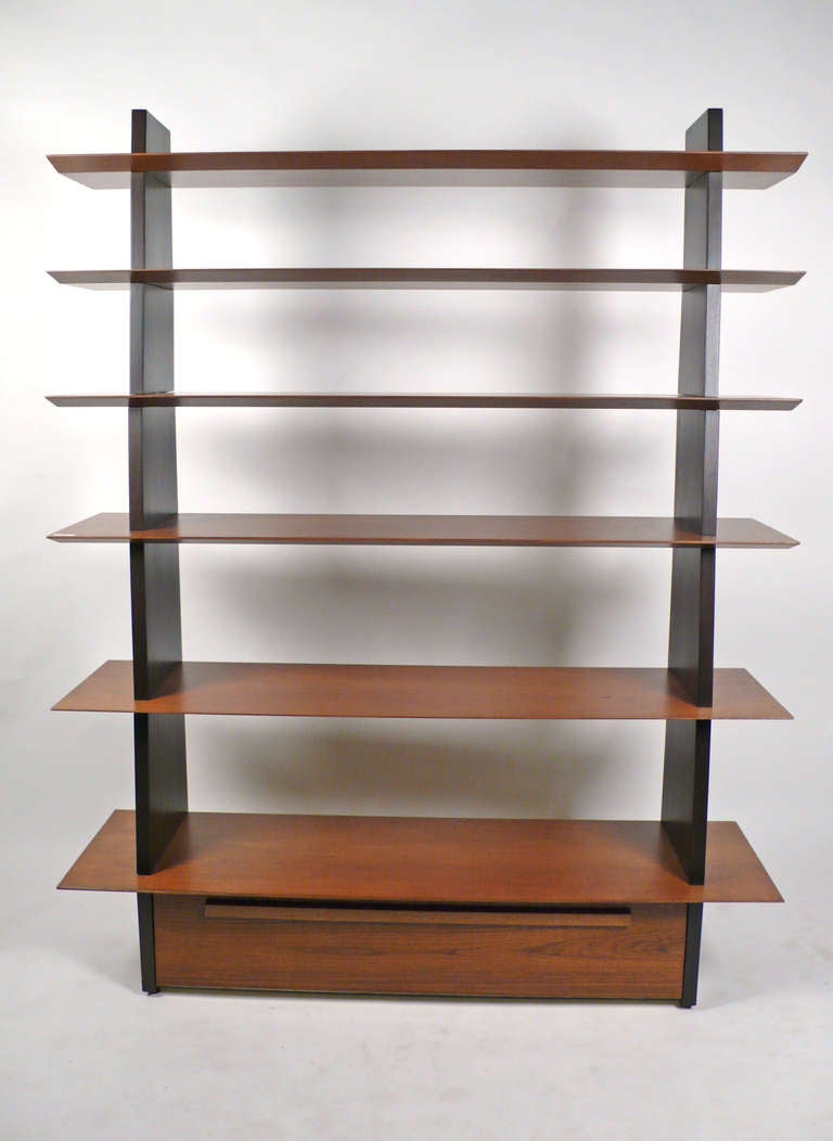 Custom Impressive Bookcase model 5264 designed by Edward Wormley for Dunbar- 1949. The bookcase features a drop front door concealing storage.