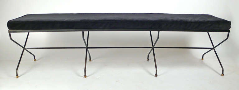 Unique wrought iron bench with brass ball finials. Very reminiscent of Jean Royere but attributed to Salterini. Some paint loss but excellent condition. Includes velvet upholstered seat cushion attached to a formica top. Would also serve as a coffee